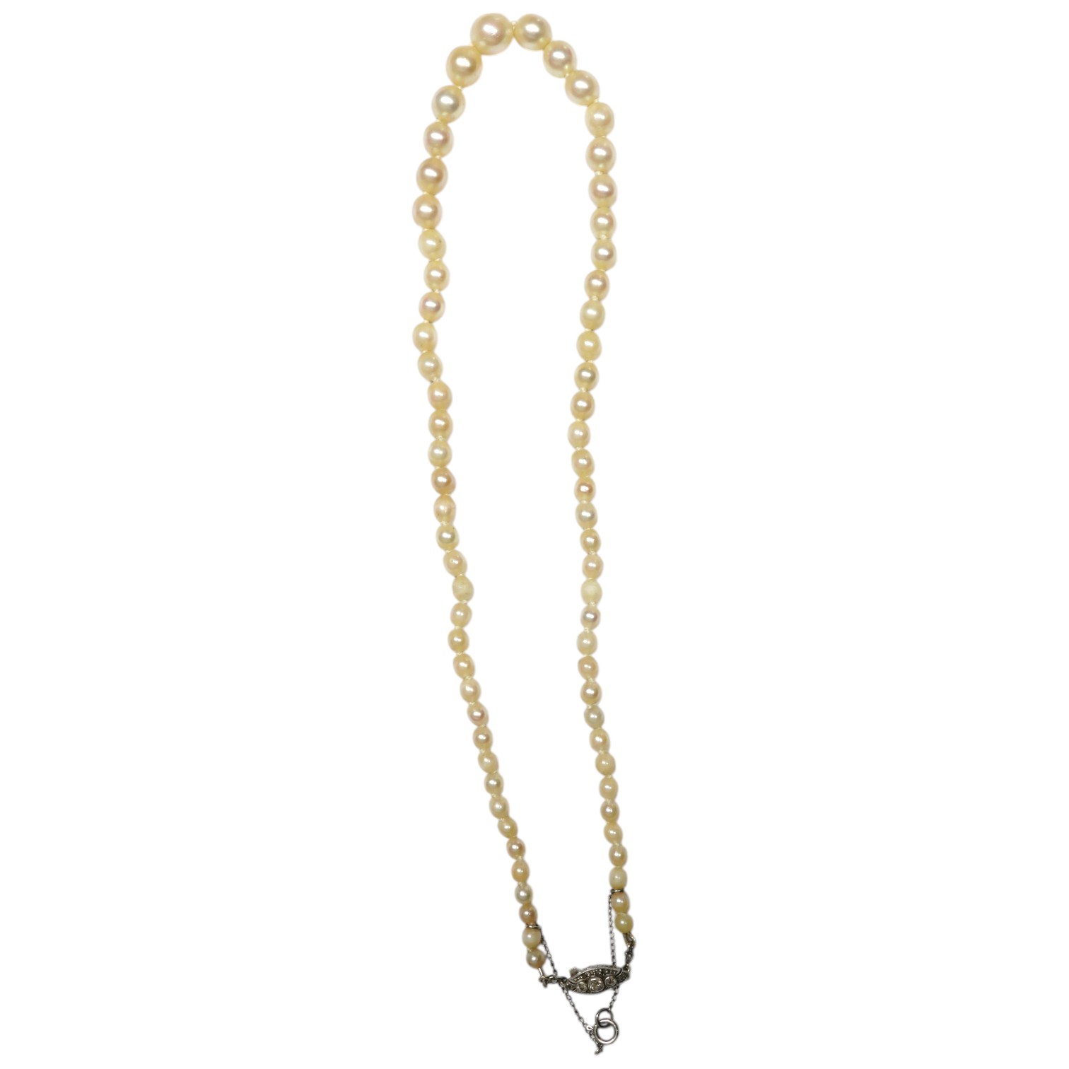 A single strand graduated cultured pearl choker necklace, with a three stone diamond set engraved white metal clasp, 36cm